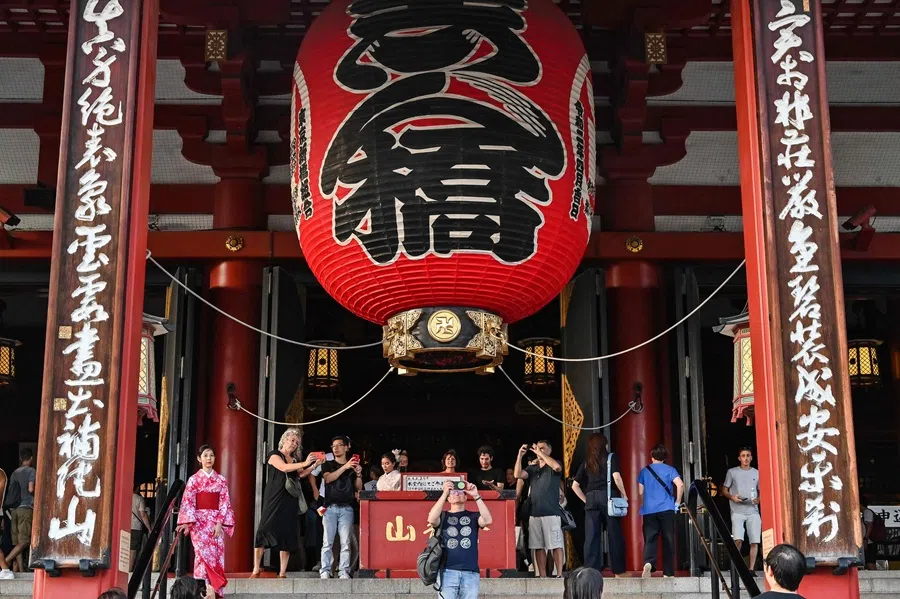 Visitors take photos during a visit to Sensoji Temple in the Asakusa district of central Tokyo on 16 September 2025. (Richard A. Brooks/AFP)
