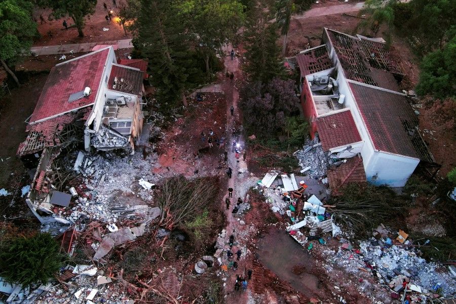 An aerial view shows damage caused following a mass infiltration by Hamas gunmen from the Gaza Strip, in Kibbutz Beeri in southern Israel, 11 October 2023. (Ilan Rosenberg/Reuters)
