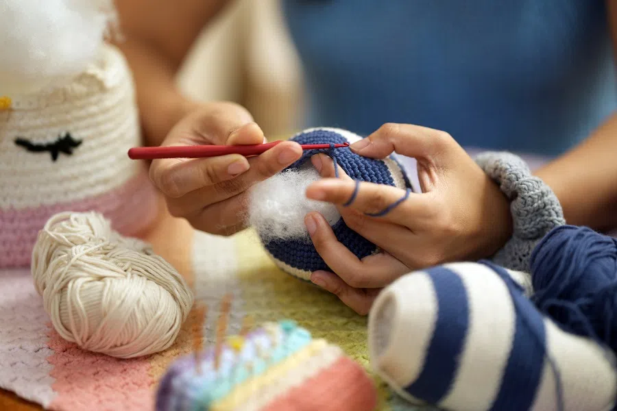 A person crochets at a crafting store in Singapore. (SPH Media)