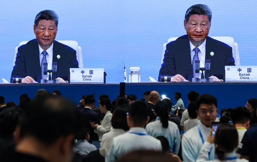 Journalists work in the media centre as a screen broadcasts Chinese President Xi Jinping delivering a speech during the plenary session of the 2025 Shanghai Cooperation Organisation (SCO) summit in Tianjin, China, on 1 September 2025.