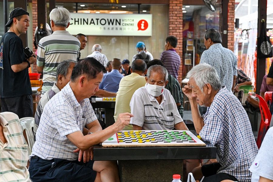 Elderly people play checkers game in Chinatown in Singapore on 26 January 2024. (Photo by Roslan Rahman/AFP)