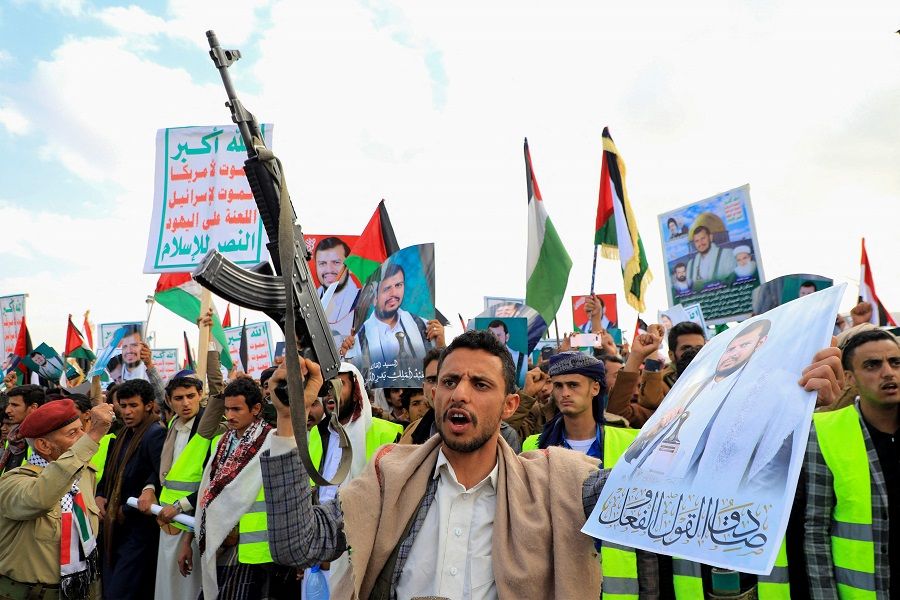 Yemenis brandishing their guns chant slogans during a march in solidarity with the people of Gaza, in the Houthi-controlled capital Sanaa on 15 December 2023. (Mohammed Huwais/AFP)