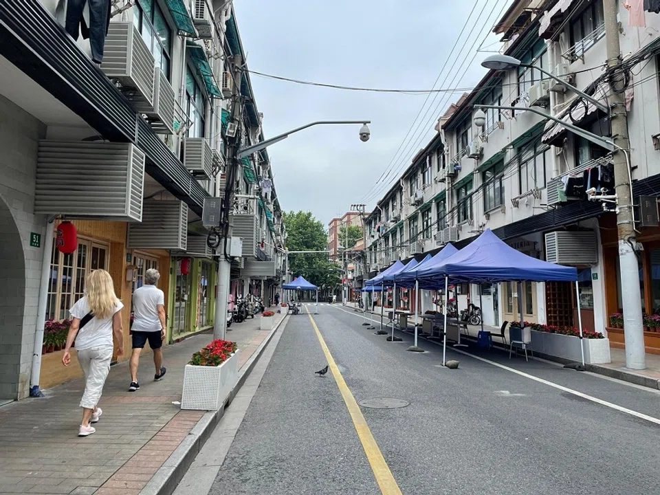 One of the near-empty streets in Shanghai, lined with PCR test tents.