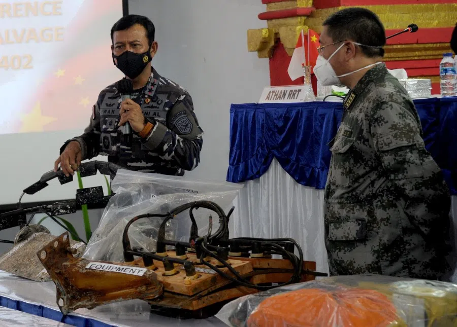 Rear Admiral Iwan Nurcahyanto (left) of Indonesia stands with Colonel Chen Yongjing of China during their joint press conference on Lanal base in Denpasar, on Indonesia resort island of Bali, 18 May 2021, (Sonny Tumbelaka/AFP)