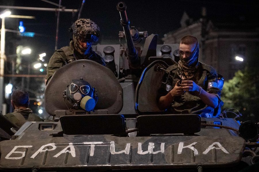 Members of Wagner Group look from a military vehicle with the sign read as "Brother" in Rostov-on-Don late on 24 June 2023. (Roman Romokhov/AFP)