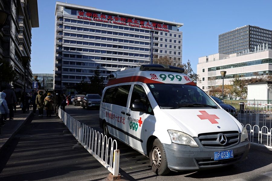 An ambulance leaves a children's hospital in Beijing, China, 24 November 2023. (Florence Lo/Reuters)