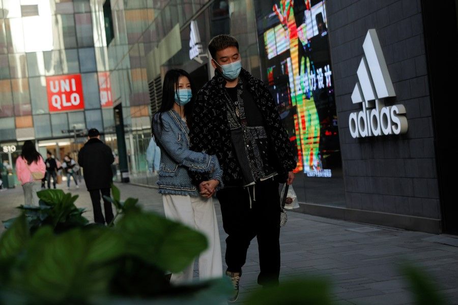 Adidas and Uniqlo stores in a shopping area in Beijing, China, 28 March 2021. (Thomas Peter/Reuters)