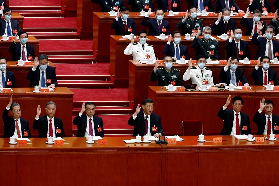 Chinese President Xi Jinping and other officials vote during the closing ceremony of the 20th Party Congress of the Chinese Communist Party, at the Great Hall of the People in Beijing, China, 22 October 2022. (Tingshu Wang/Reuters)
