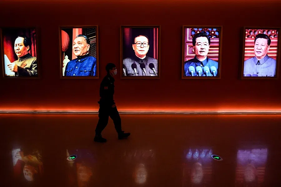 A man walks past portraits of (left to right) late Chinese chairman Mao Zedong and former Chinese leaders Deng Xiaoping, Jiang Zemin, Hu Jintao and current president Xi Jinping at Yan'an Revolutionary Memorial Hall in Yan'an city, Shaanxi province, China, on 15 October 2022, one day ahead of the 20th Party Congress. (Jade Gao/AFP)