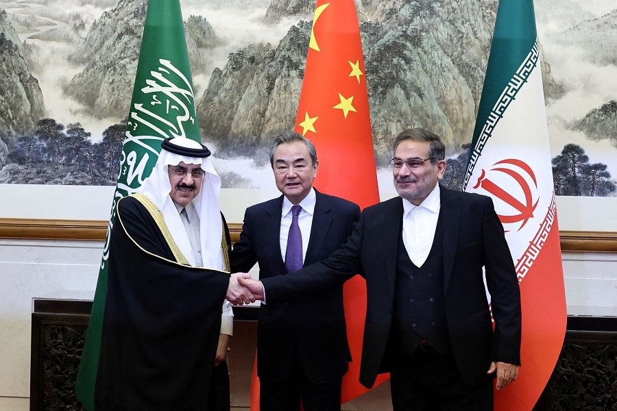 Wang Yi (centre), a member of the Political Bureau of the Communist Party of China (CPC) Central Committee and director of the Office of the Central Foreign Affairs Commission, Ali Shamkhani (right), the secretary of Iran's Supreme National Security Council, and Minister of State and national security adviser of Saudi Arabia Musaad bin Mohammed Al Aiban pose for pictures during a meeting in Beijing, China, 10 March 2023. (China Daily via Reuters)