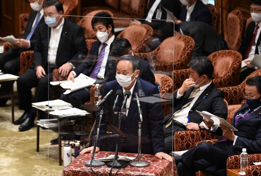 Japan's Prime Minister Yoshihide Suga (centre) answers a question during a lower house budget committee session at parliament in Tokyo on 11 May 2021. (Kazuhiro Nogi/AFP)