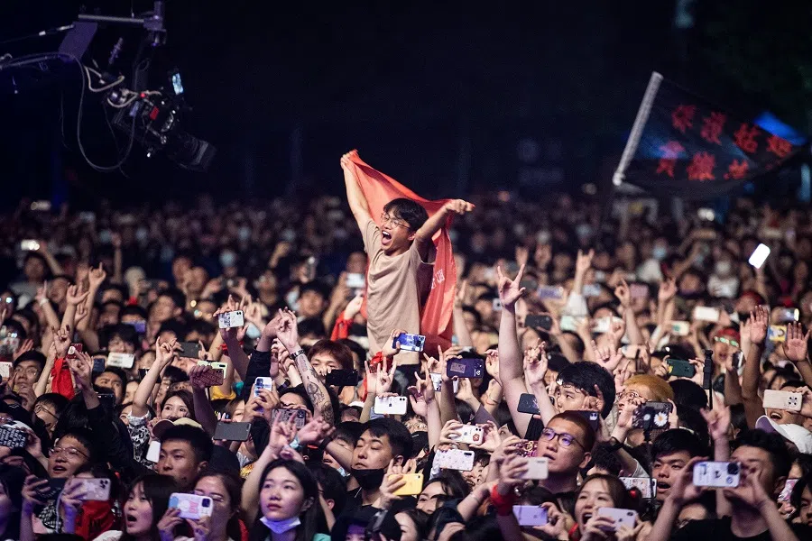 This photograph taken on 1 May 2021 shows people watching a performance at the Strawberry Music Festival in Wuhan, Hubei province, China. (STR/AFP)