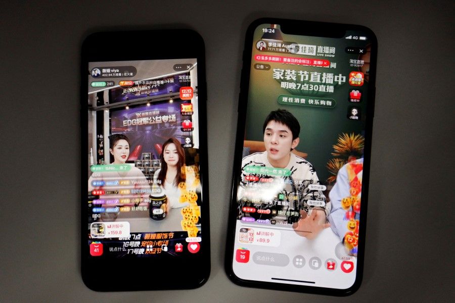 Chinese livestreamers are seen on Alibaba's e-commerce app Taobao displayed on mobile phones in this illustration picture taken 14 December 2021. (Florence Lo/Reuters)