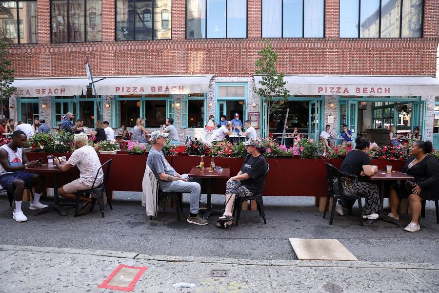 People dine at Hair of the Dog on Orchard street in lower Manhattan, New York, US, on 4 July 2020. (Caitlin Ochs/Reuters)