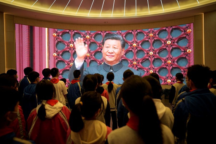 Students gather in front of a screen displaying an image of Chinese President Xi Jinping, at the Memorial of the First National Congress of the Communist Party of China in Shanghai, China, 10 March 2023. (Aly Song/Reuters)
