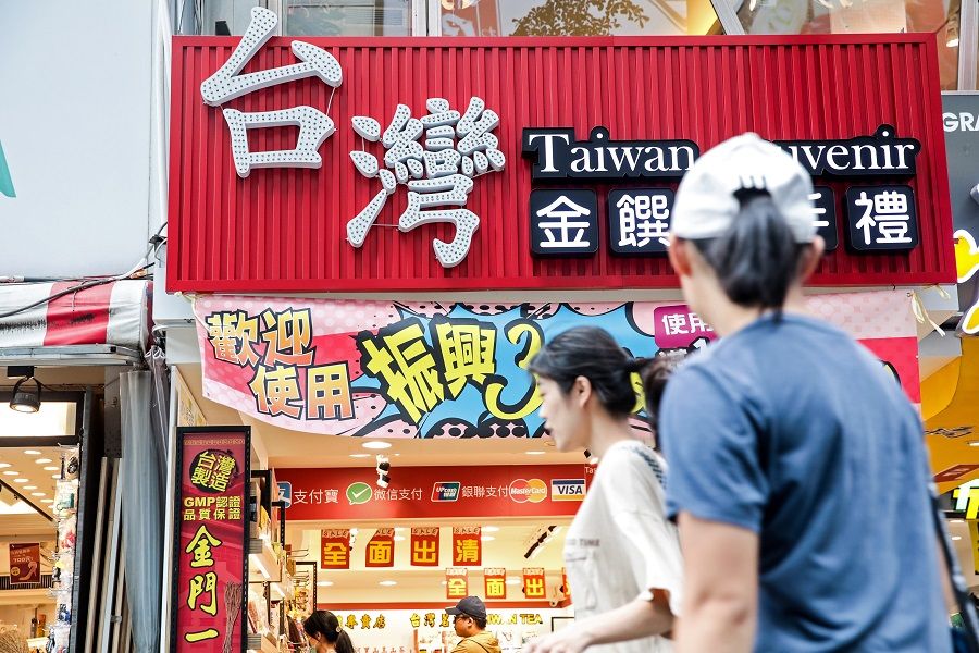 Pedestrians walk past a souvenir store displaying the Chinese characters for "Taiwan" in Taipei, Taiwan, on 30 July 2020. (I-Hwa Cheng/Bloomberg)