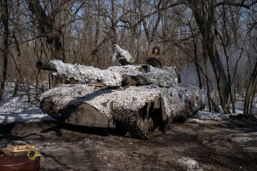 A Ukrainian serviceman of the 17th Independent Tanks Brigade drives a T-64 tank, as Russia's attack on Ukraine continues, near the frontline town of Bakhmut, Donetsk region, Ukraine, 23 February 2023. (Marko Djurica/Reuters)