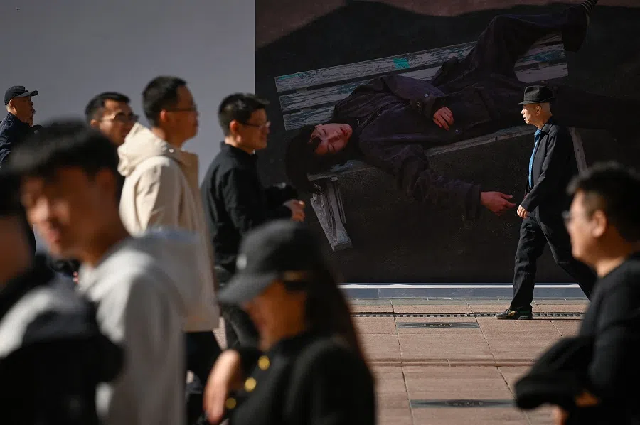People walk along a business street in Beijing, China, on 23 October 2024. (Wang Zhao/AFP)