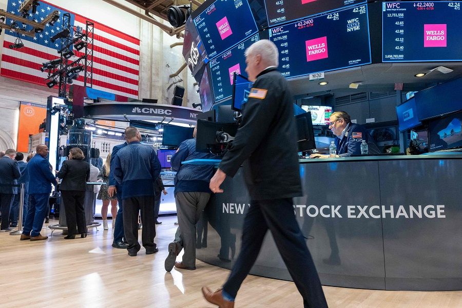 People walk on the floor of the New York Stock Exchange (NYSE) on 13 September 2023. (Spencer Platt/AFP)