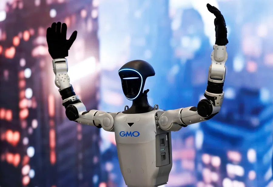 GMO AI and Robotics' humanoid robot Unitree G1 raises its arms at the GMO booth in the International Robot Exhibition 2025 at Tokyo Big Sight in Tokyo, Japan, on 3 December 2025. (Manami Yamada/Reuters)