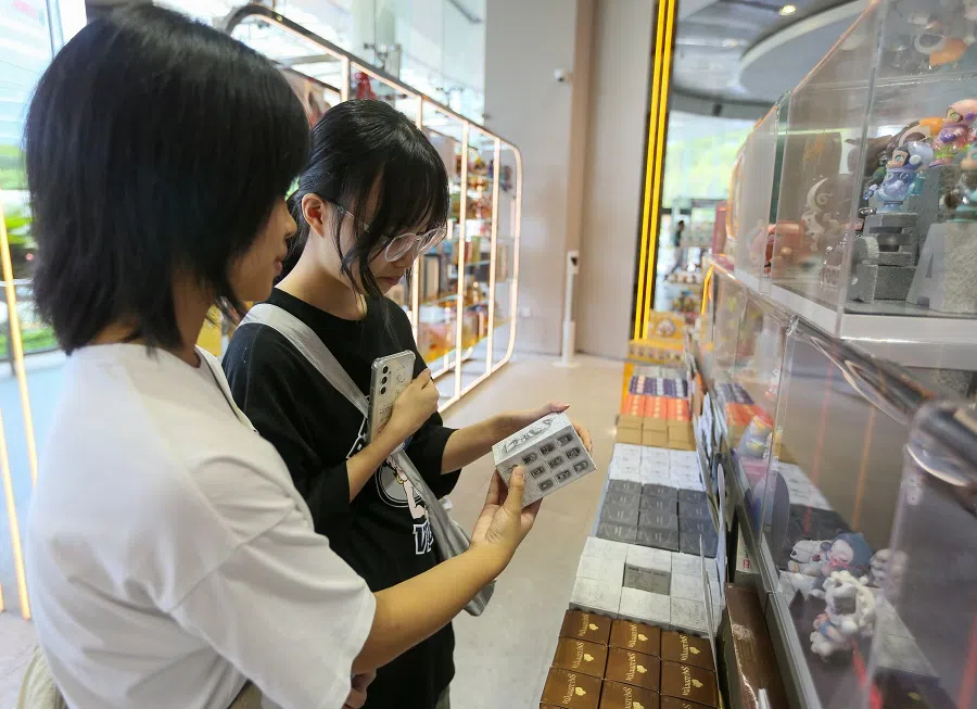 Two youths shopping at the Pop Mart store in Singapore. (SPH Media)