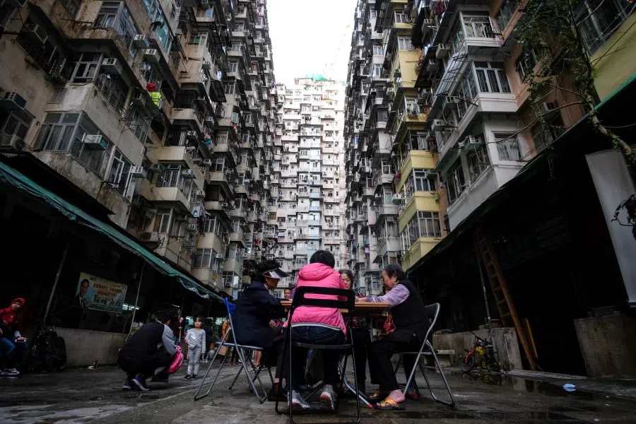 Women play cards in a living quarter of dense buildings in Kowloon, Hong Kong, 2019. (iStock)