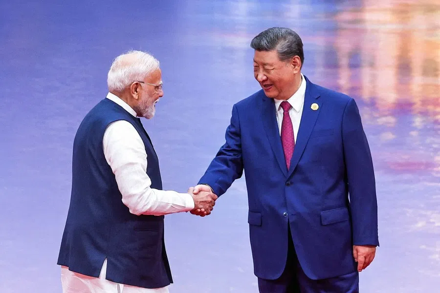 In this handout photograph taken on 31 August 2025 and released by the Indian Press Information Bureau (PIB), India’s Prime Minister Narendra Modi (left) and China’s President Xi Jinping shake hands during the welcoming ceremony of the Shanghai Cooperation Organization (SCO) summit in Tianjin.