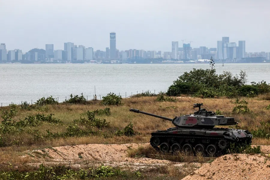 A decommissioned tank is seen outside of the Triangle Fortress in Kinmen as China's Xiamen city is visible in the background, 28 October 2025. (I-Hwa Cheng/AFP)