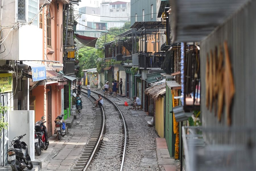 Vietnam has a seemingly insatiable appetite for domestic infrastructure investment. The photo shows a resident sitting on Hanoi's popular train street on October 10, 2019 following a municipal authorities order to deal with cafes and "ensure safety" on the railway track. (Nhac Nguyen/AFP)