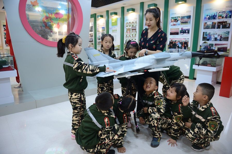 First grade elementary school students look at aviation models in school, Hohhot, Inner Mongolia, China, 31 August 2020. (CNS)