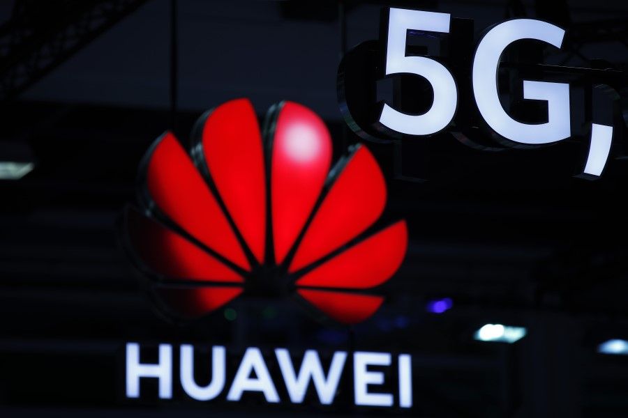 In this file photo taken on 15 October 2019, illuminated Huawei and 5G signs are on display during the 10th Global mobile broadband forum hosted by Chinese tech giant Huawei in Zurich. (Stefan Wermuth/AFP)