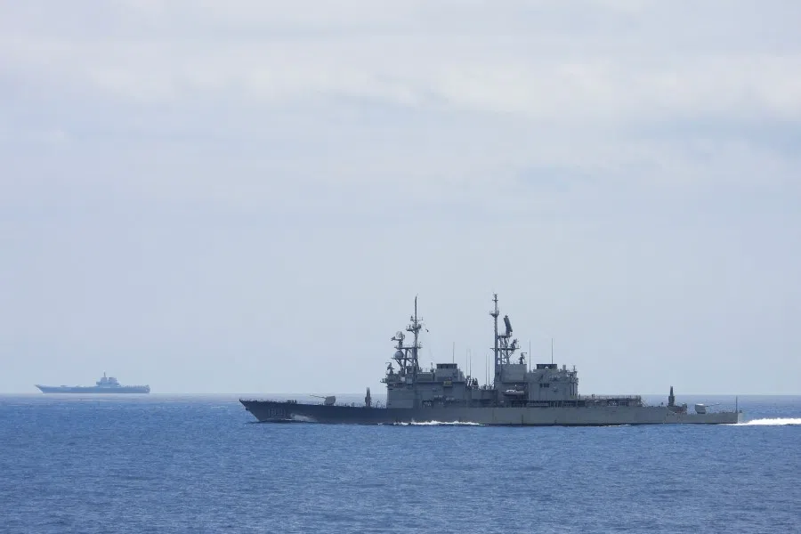This undated handout photo released by the Taiwan Defence Ministry on 13 September 2023 shows Chinese aircraft carrier Shandong (left) while being monitored by a Taiwanese Keelung class warship at sea. (Handout/Taiwan Defense Ministry/AFP)