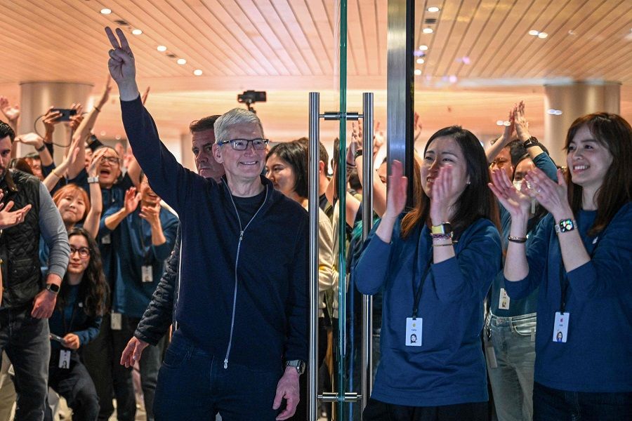 Apple's CEO Tim Cook (L) gestures during the opening of Shanghai's new Apple retail store in Shanghai on 21 March 2024. (AFP)