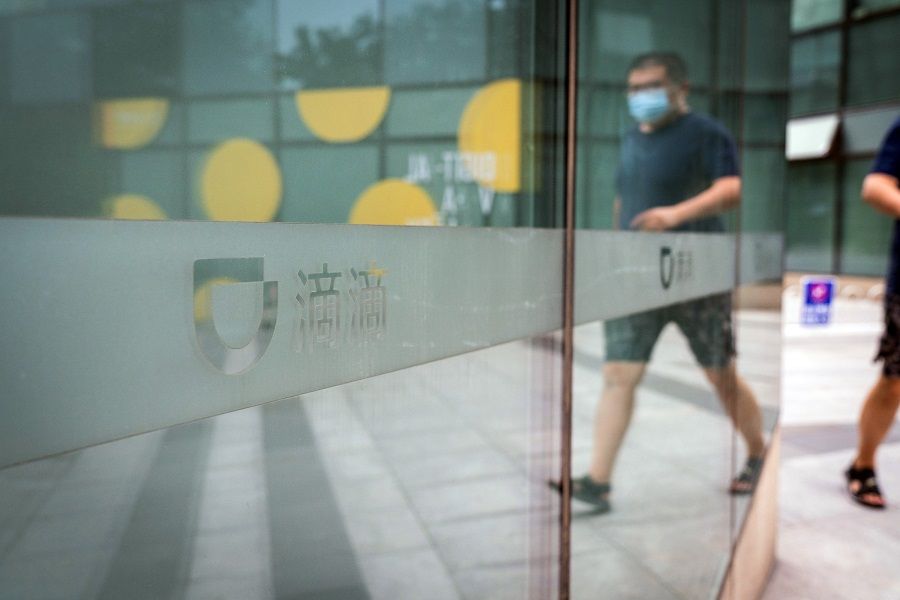 A pedestrian passes a logo at the Didi Global Inc. headquarters in Beijing, China on 5 July 2021. (Yan Cong/Bloomberg)