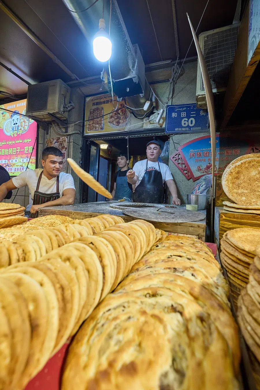Xinjiang’s baked naan comes in a variety of sizes and flavours, from sesame and onion to rose jam, chilli and meat fillings. At dinnertime, naan bakers constantly pull fresh, piping hot naan from the tandoor, never worrying about not being able to sell everything. In Xinjiang, naan can be kept for a few weeks without going bad.