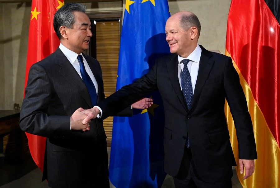 German Chancellor Olaf Scholz (right) shakes hands with China's Director of the Office of the Central Foreign Affairs Commission Wang Yi at the Munich Security Conference (MSC) in Munich, southern Germany, on 17 February 2023. (Thomas Kienzle/AFP)