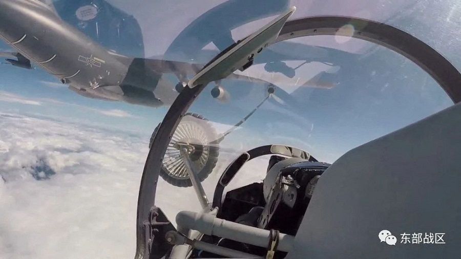 An Air Force aircraft under the Eastern Theater Command of China's People's Liberation Army (PLA) gets refuelled mid-air during military exercises in the waters around Taiwan, in this screengrab from a 4 August 2022 video released on 5 August 2022. (Eastern Theater Command/Handout via Reuters)