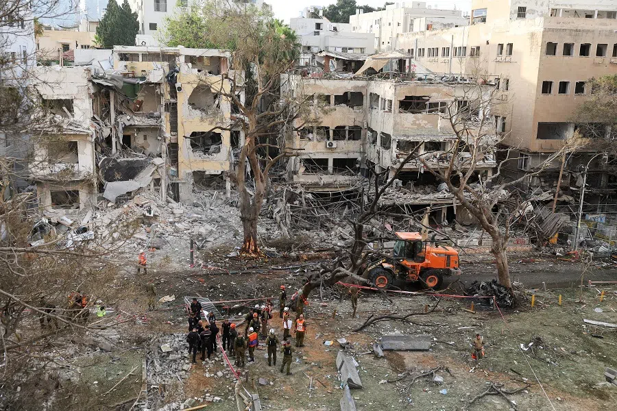 Emergency personnel work at an impact site after missiles were launched from Iran to Israel, in Tel Aviv, Israel, on 16 June 2025.