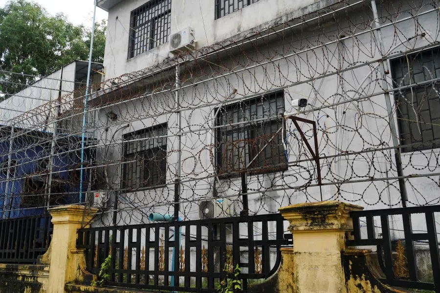Barbed wire fences are seen outside a shuttered Great Wall Park compound where Cambodian authorities said they had recovered evidence of human trafficking, kidnapping and torture during raids on suspected cybercrime compounds in the coastal city of Sihanoukville, Cambodia, 21 September 2022. (Cindy Liu/Reuters)