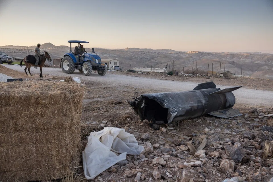 The remains of an Iranian missile that fell at an outpost near the Israeli settlement of Tekoa in the occupied West Bank, on 29 June 2025, in the aftermath of the 12-day war between Israel and Iran. (Menahem Kahana/AFP)