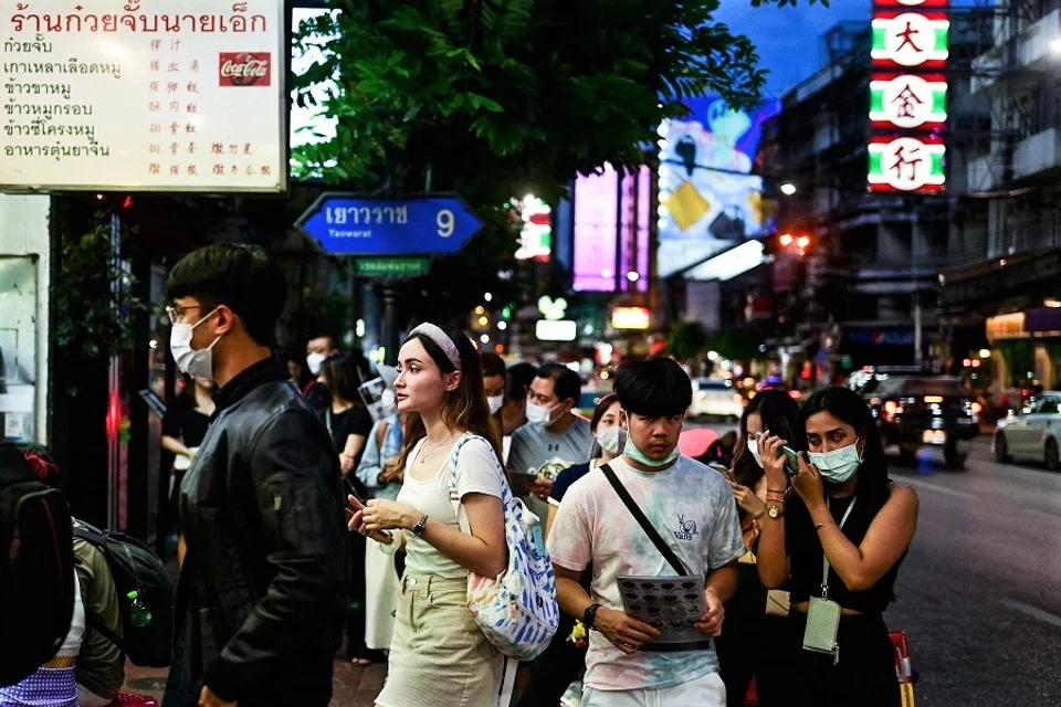 People stand in a queue outside a restaurant along the popular Yaowarat Road in the Chinatown area of Bangkok, Thailand, on 5 September 2022. (Manan Vatsyayana/AFP)