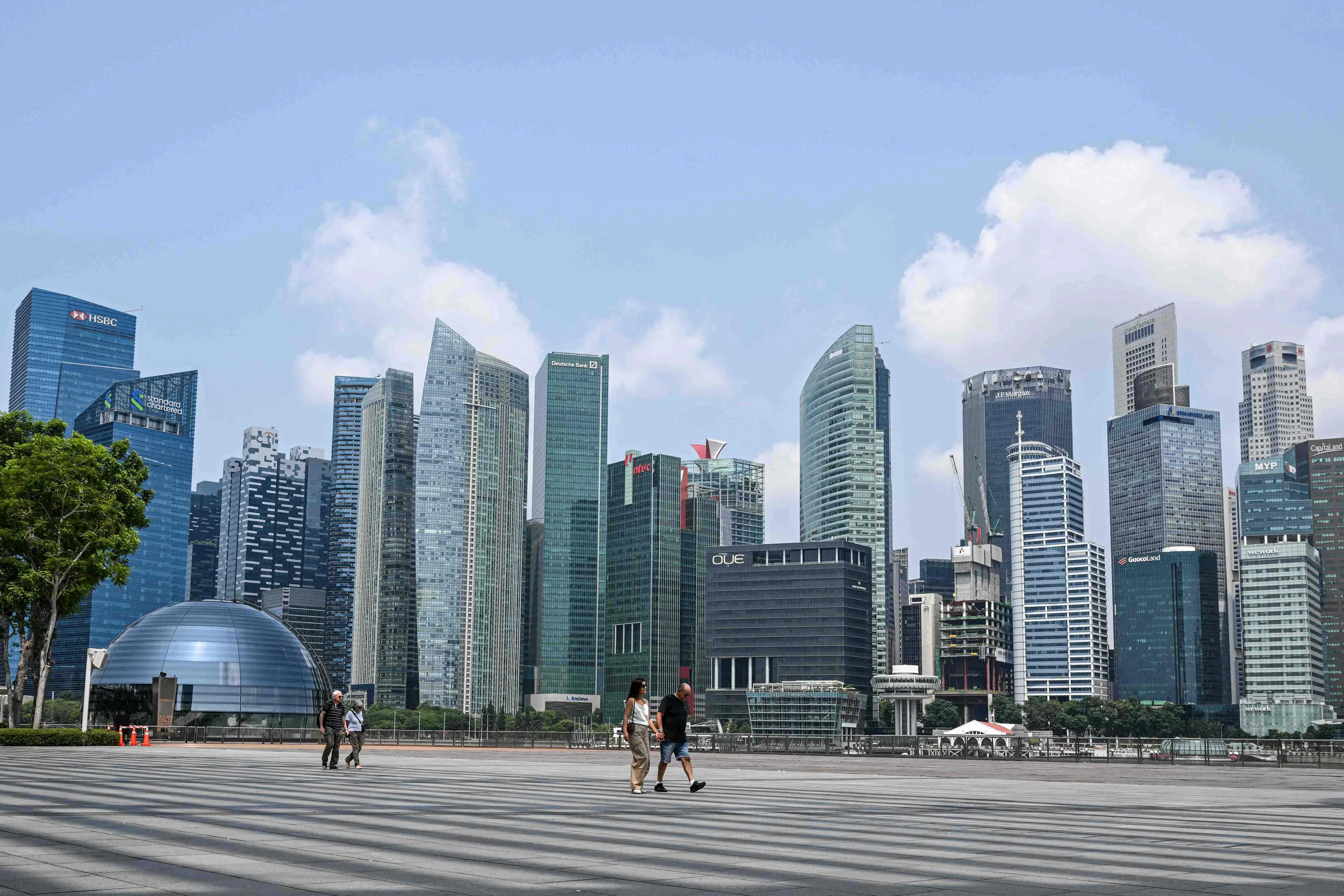 People walk along the promenade next to Marina Bay in Singapore on 8 September 2026.