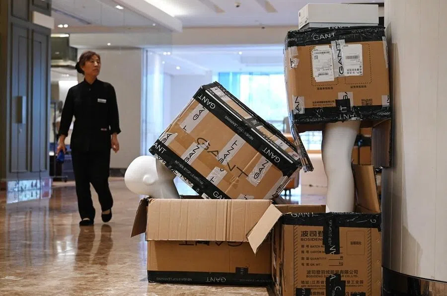 A mannequin sits in boxes in the Galeries Lafayette mall, a day before it closes, in Beijing on May 26, 2026. The closure of France's Galeries Lafayette's first China flagship on May 27, takes place against a backdrop of a sluggish post-pandemic economy and shifting consumption practices. (Photo by GREG BAKER / AFP) / TO GO WITH: China-luxury-retail-economy-consumption, FOCUS by Mary YANG and Agatha CANTRILL in Shanghai