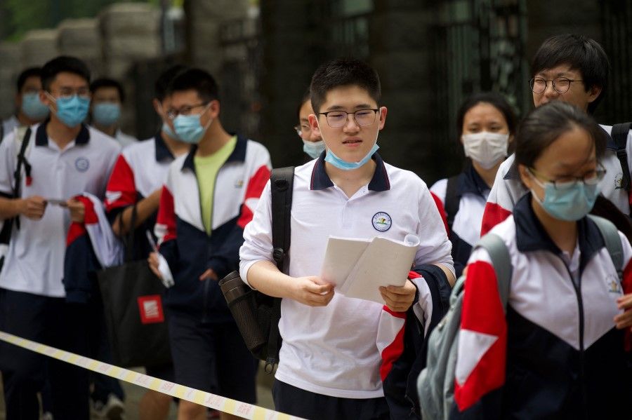 Students enter a school to sit for the first day of the National College Entrance Examination (NCEE), known as "gaokao" in Beijing on 7 July 2021. (Wang Zhao/AFP)