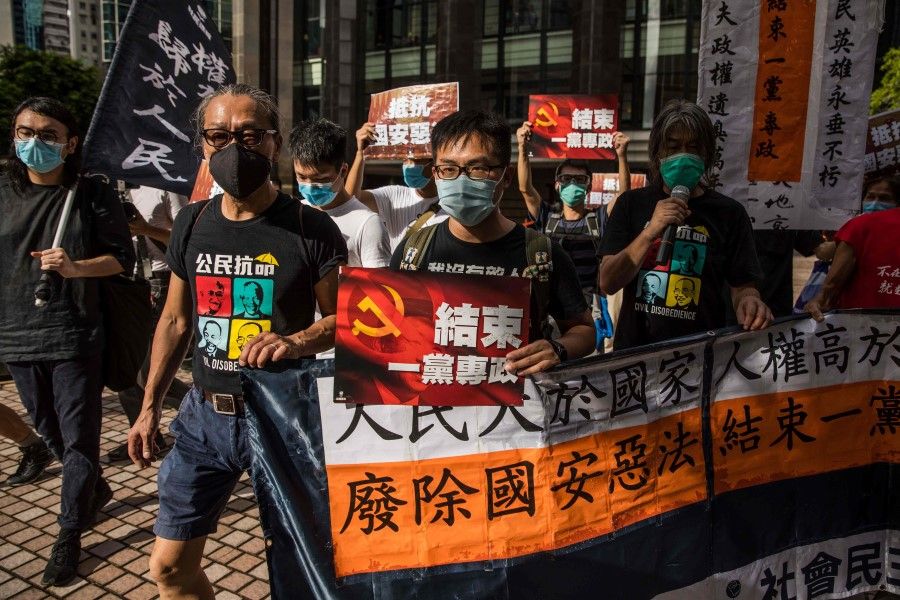 Pro-democracy protesters march during a rally against a new national security law in Hong Kong on 1 July 2020. (Dale de la Rey/AFP)