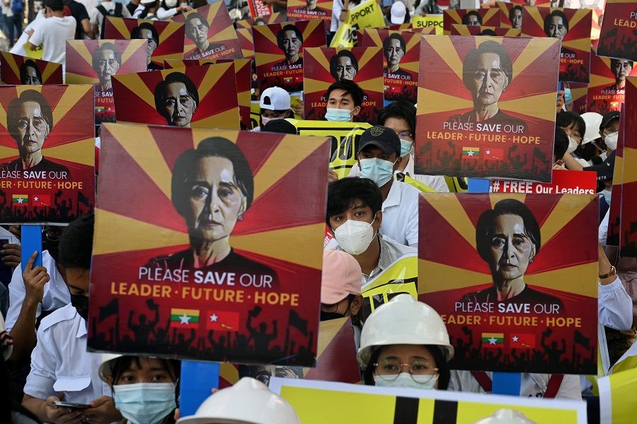 Protesters hold signs calling for the release of detained Myanmar civilian leader Aung San Suu Kyi at a demonstration against the military coup in Yangon, Myanmar, on 14 February 2021. (Sai Aung Main/AFP)