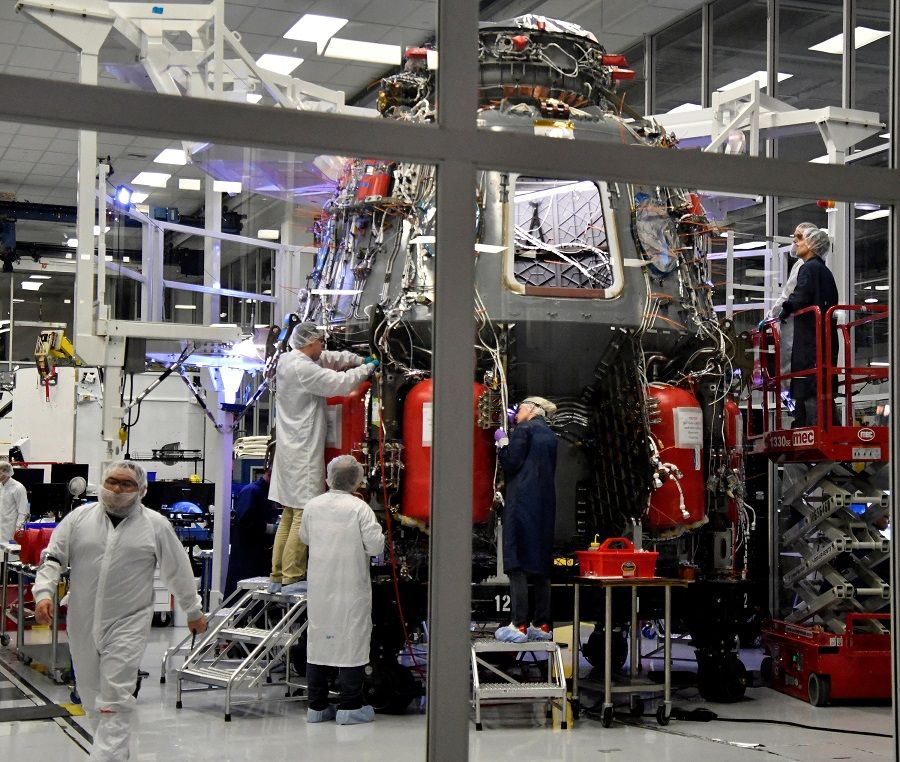 SpaceX technicians work on the next Crew Dragon Demo-2 craft as NASA Administrator Jim Bridenstine tours SpaceX headquarters in Hawthorne, California, US, on 10 October 2019. (Gene Blevins/Reuters)