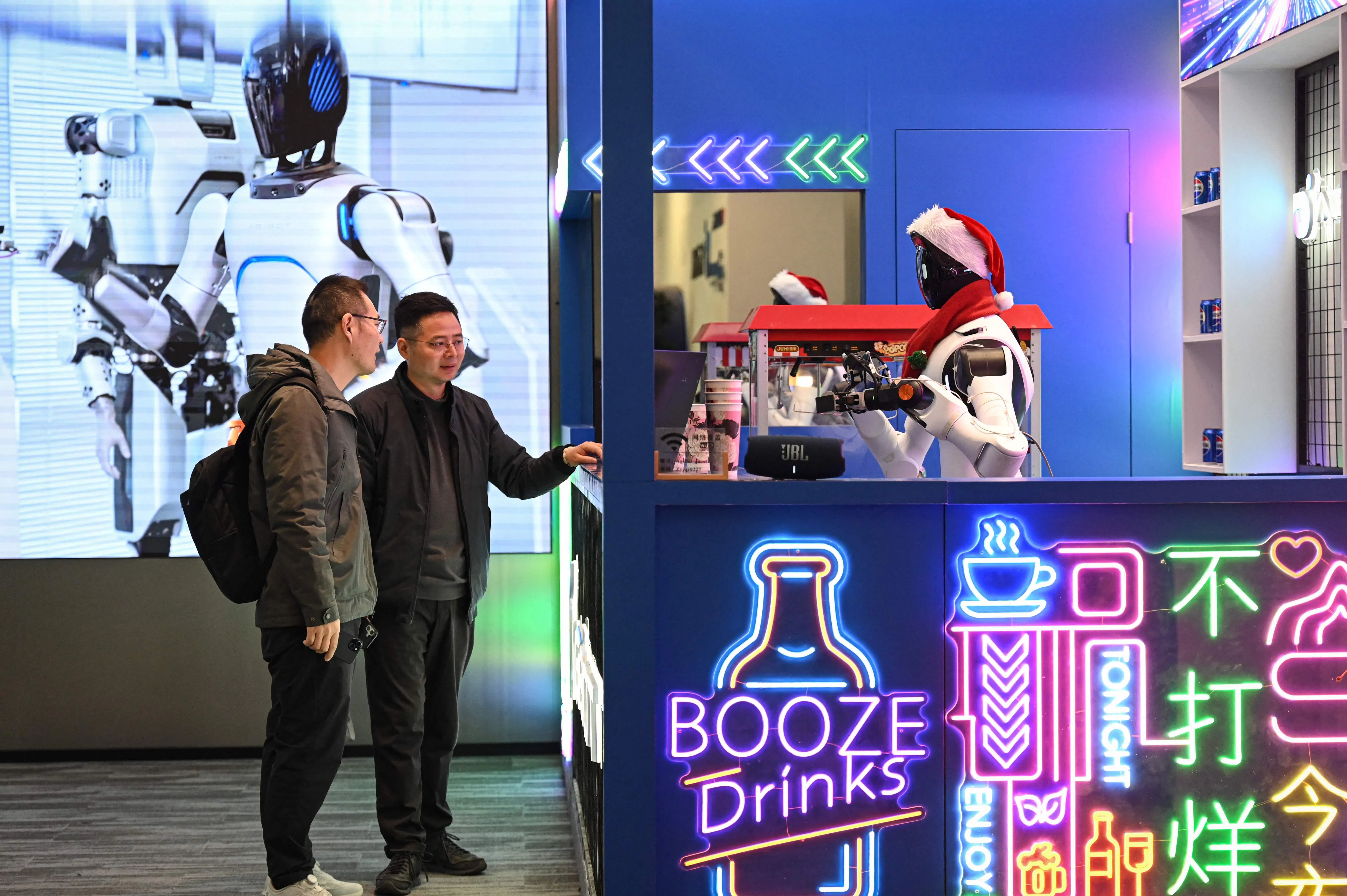 The photo taken on 11 March 2026 shows a humanoid robot preparing popcorn at a stand in Agibot's headquarter in Shanghai.