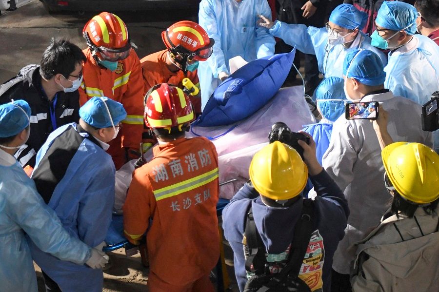 A survivor is pushed into an ambulance after being rescued from the building that collapsed in Changsha, Hunan province, China, on 2 May 2022. (CNS)