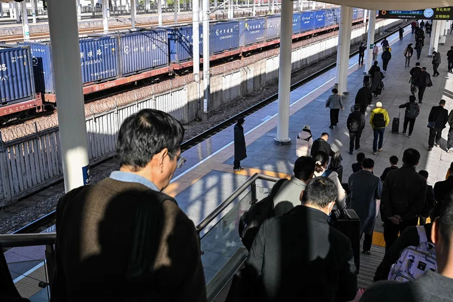 Passengers walk to a platform at the railway station in Quzhou, Zhejiang province, China, on 26 November 2025. (Hector Retamal/AFP)